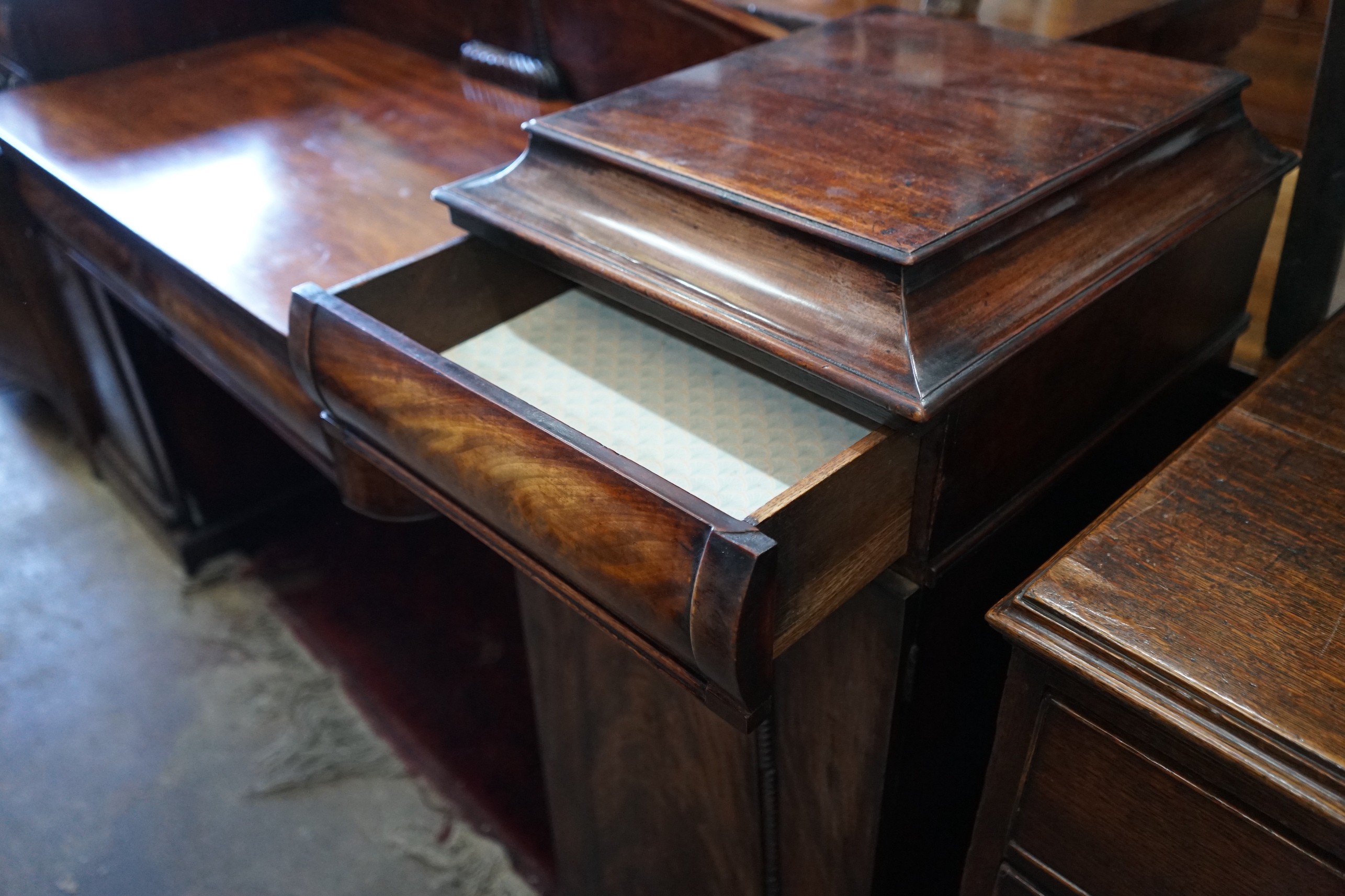 A Regency carved mahogany pedestal sideboard, length 186cm, depth 54cm, height 115cm